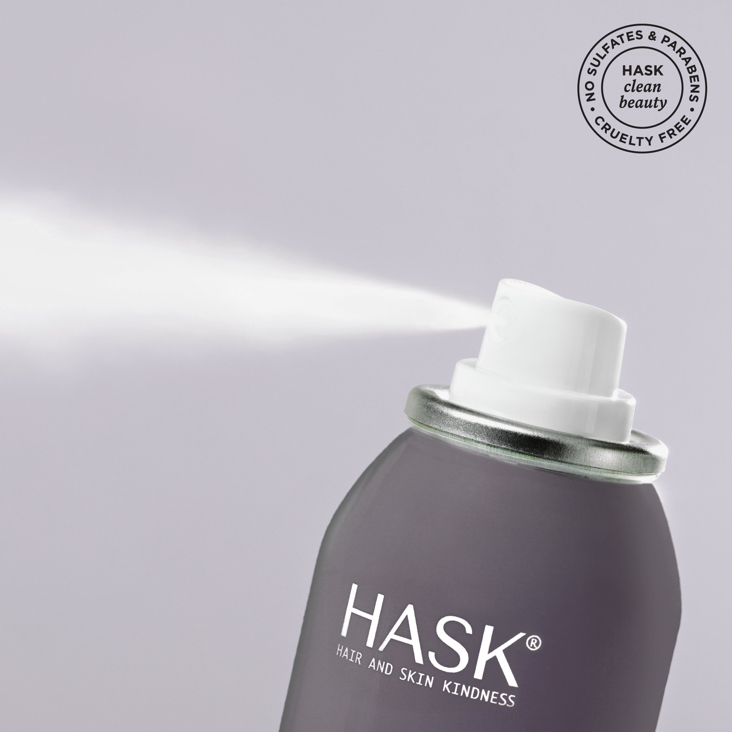 spraying hask charcoal dry shampoo